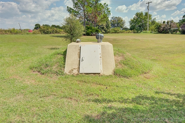 view of storm shelter featuring a yard