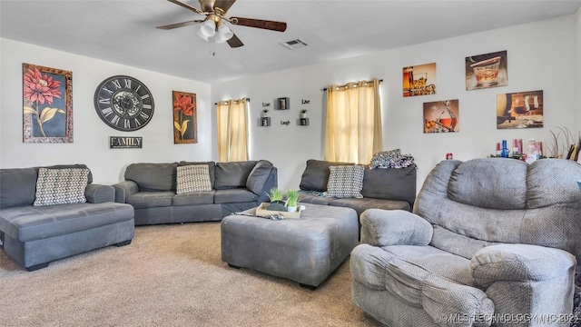 living area featuring visible vents, carpet, and a ceiling fan