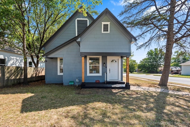 bungalow-style house with a front lawn