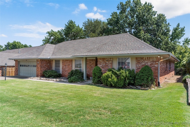 ranch-style home featuring a garage and a front lawn