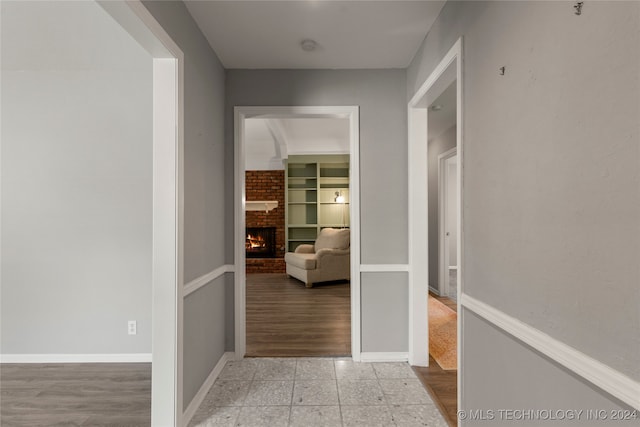 hall with light hardwood / wood-style flooring and built in features