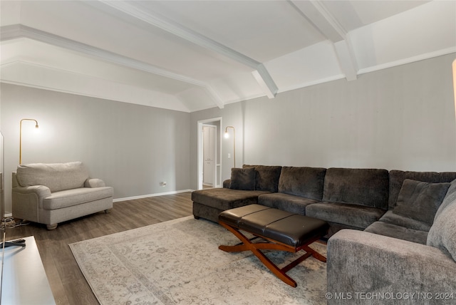 living room featuring vaulted ceiling with beams and dark wood-type flooring