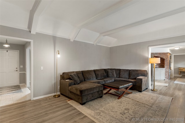 living room featuring beamed ceiling and hardwood / wood-style flooring