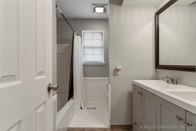 full bathroom with vanity, shower / tub combo, toilet, and tile patterned floors