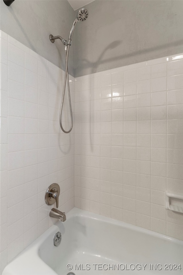 interior space featuring tiled shower / bath combo