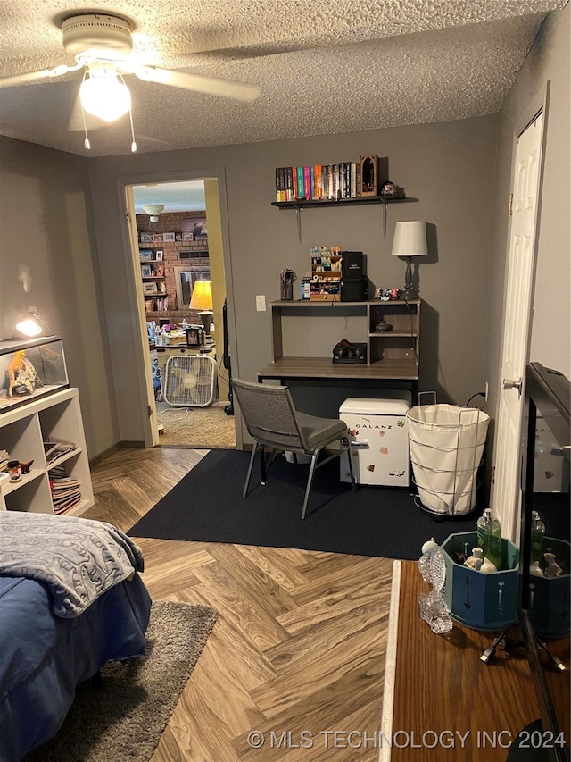 bedroom with a textured ceiling, parquet floors, and ceiling fan