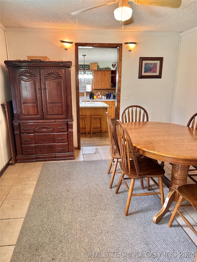 carpeted dining area featuring a textured ceiling and sink