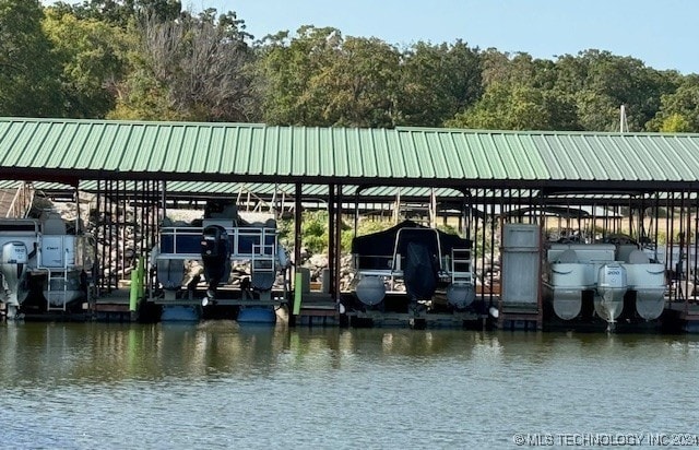 dock area with boat lift and a water view