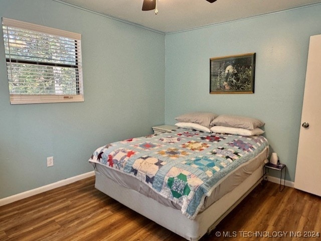 bedroom with baseboards, wood finished floors, and a ceiling fan