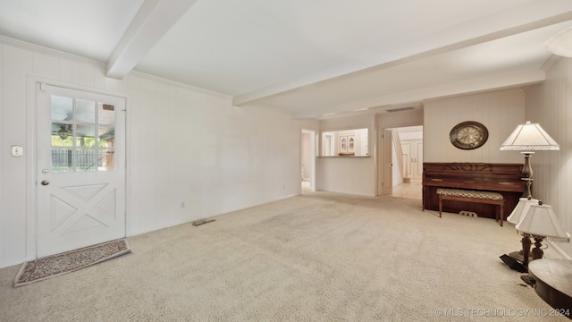 interior space with beam ceiling, carpet floors, and crown molding