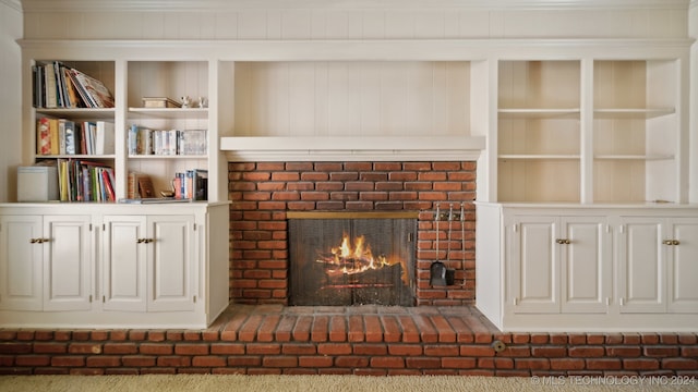 unfurnished living room featuring carpet floors, a fireplace, and ornamental molding