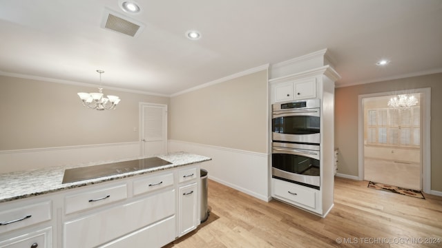 kitchen with an inviting chandelier, white cabinets, light hardwood / wood-style flooring, light stone countertops, and stainless steel double oven