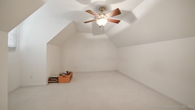 bonus room featuring ceiling fan, light colored carpet, and vaulted ceiling