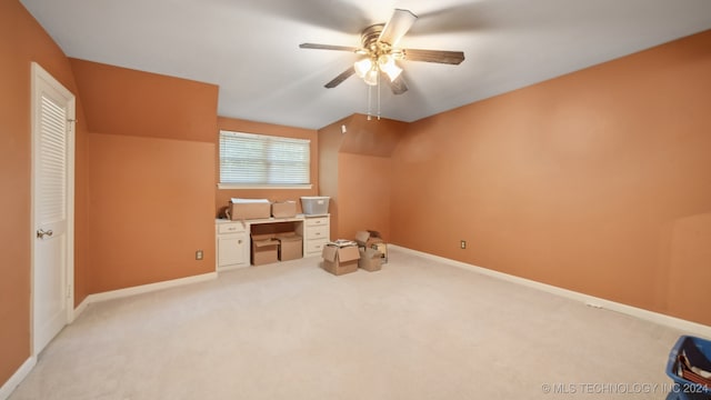 additional living space featuring ceiling fan and light carpet