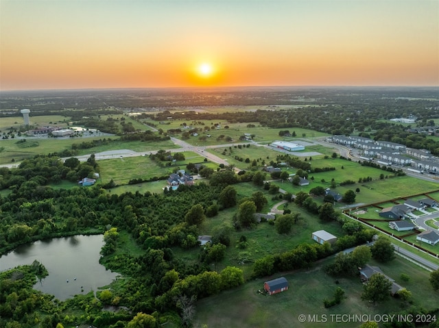 aerial view at dusk with a water view