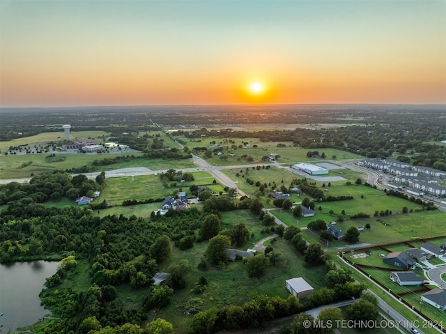 aerial view at dusk with a water view