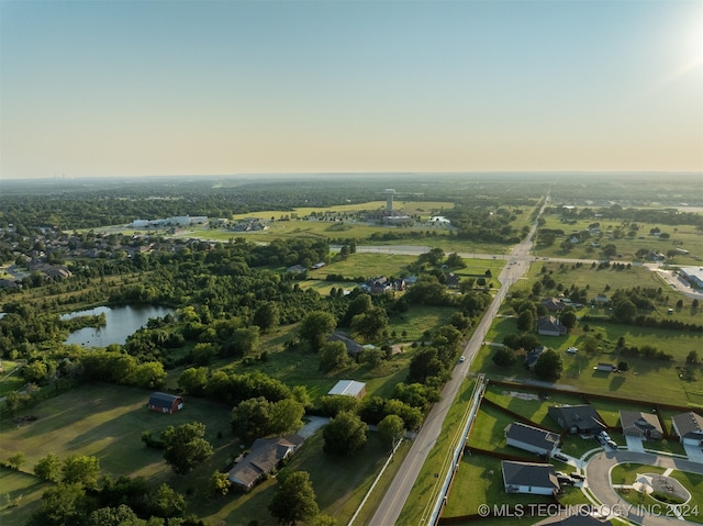 aerial view at dusk with a water view