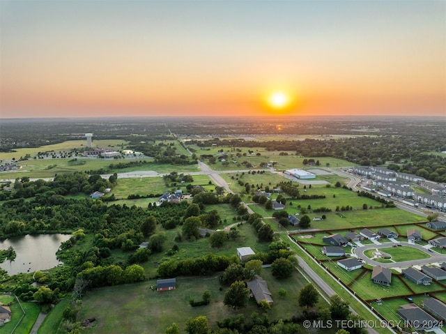 aerial view at dusk with a water view