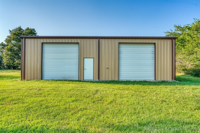 garage featuring a lawn