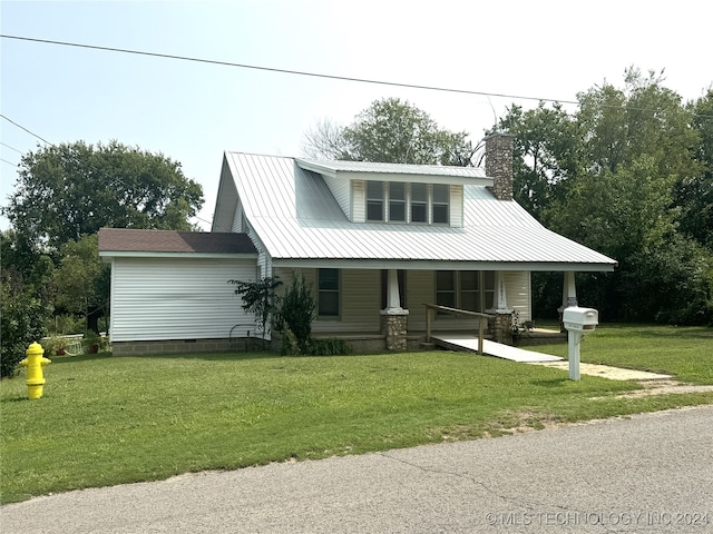 view of front of house with covered porch and a front lawn