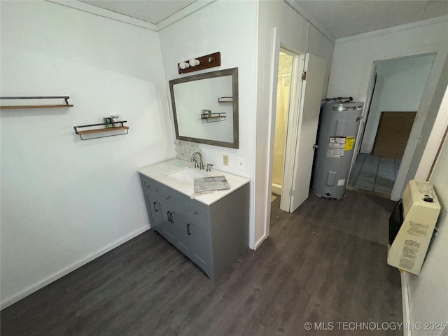 bathroom featuring electric water heater, wood finished floors, vanity, baseboards, and crown molding