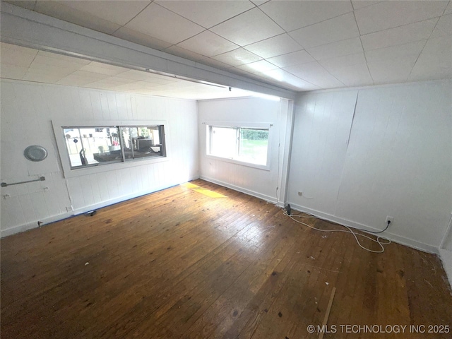 empty room featuring hardwood / wood-style flooring and baseboards