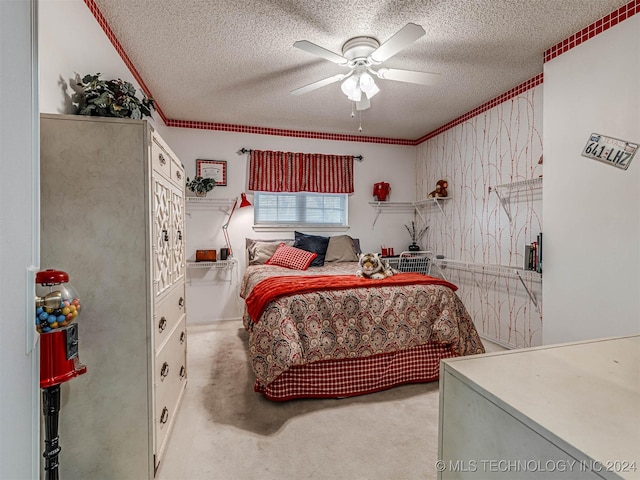 bedroom featuring ceiling fan, a textured ceiling, and ornamental molding