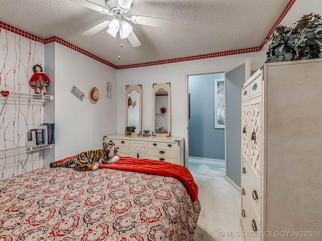 bedroom featuring carpet, a textured ceiling, ornamental molding, and ceiling fan