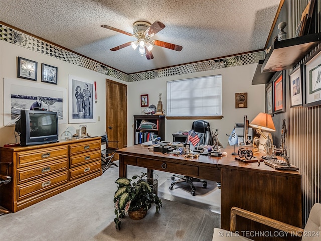 carpeted home office with a textured ceiling and ceiling fan