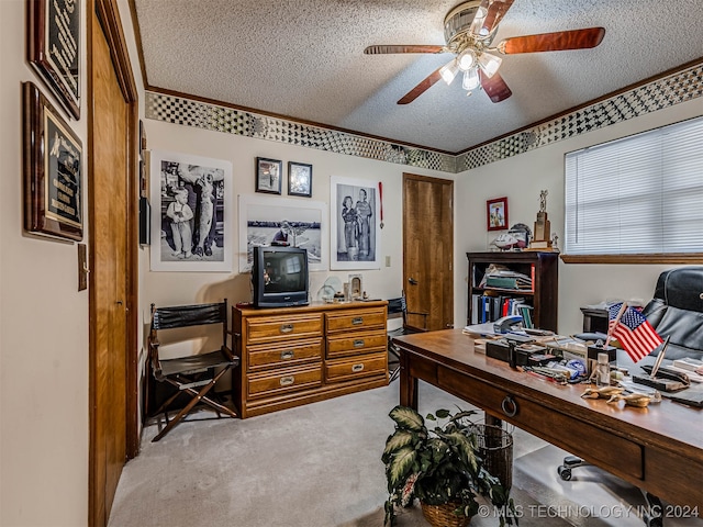 carpeted home office featuring ceiling fan and a textured ceiling