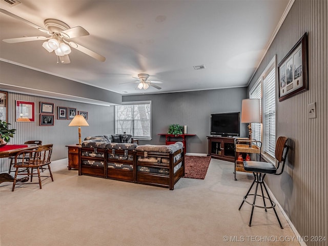 carpeted living area featuring visible vents, ceiling fan, and a healthy amount of sunlight