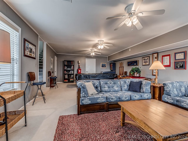 carpeted living room featuring crown molding and ceiling fan