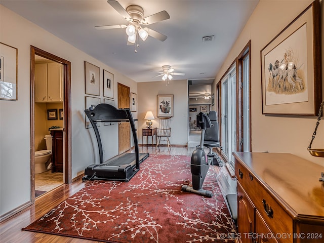 exercise room with wood-type flooring and ceiling fan