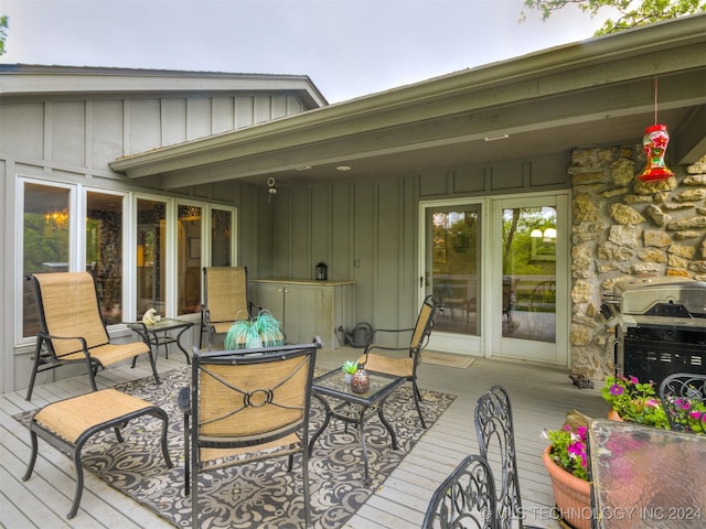 wooden deck with grilling area and an outdoor hangout area
