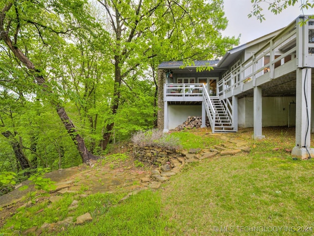 view of yard featuring a wooden deck and stairway