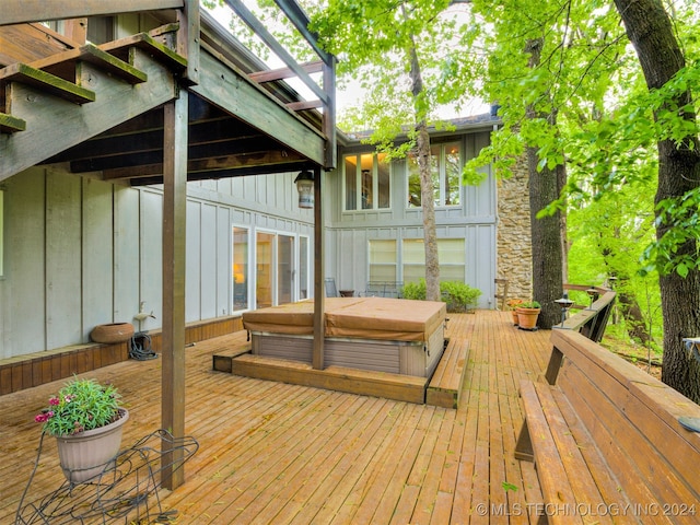 wooden terrace featuring a covered hot tub