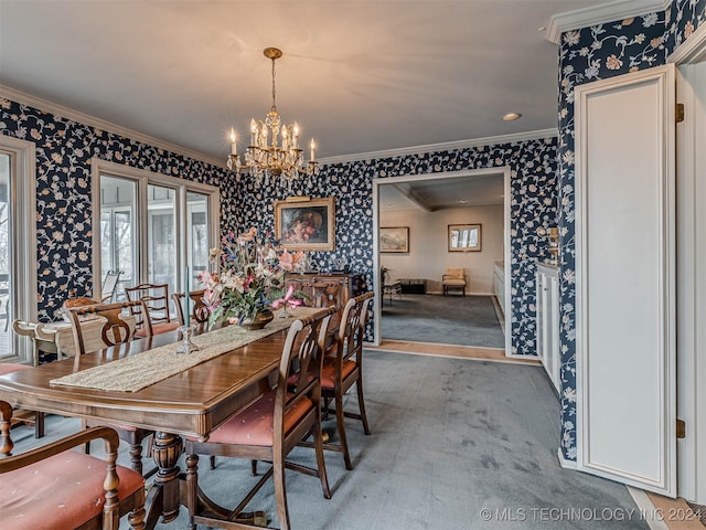 carpeted dining space with a notable chandelier, ornamental molding, and wallpapered walls