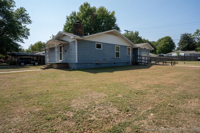 606 N B Ave, Cleveland, OK 74020 - view of home's exterior with a chimney and crawl space
