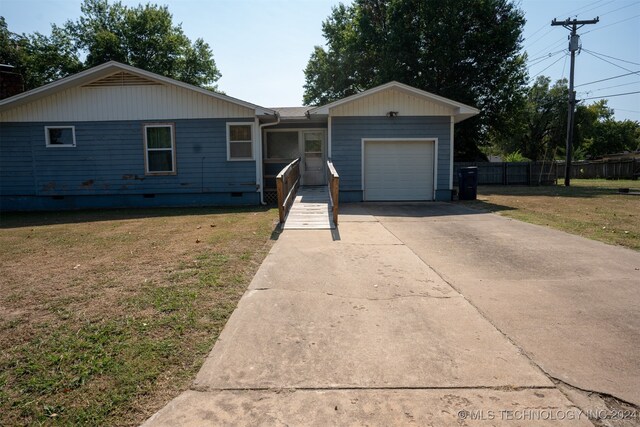 ranch-style home with a front yard and a garage