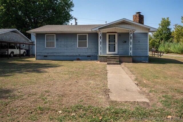 606 N B Ave, Cleveland, OK 74020 - view of front of house with crawl space, a porch, a chimney, and a front yard