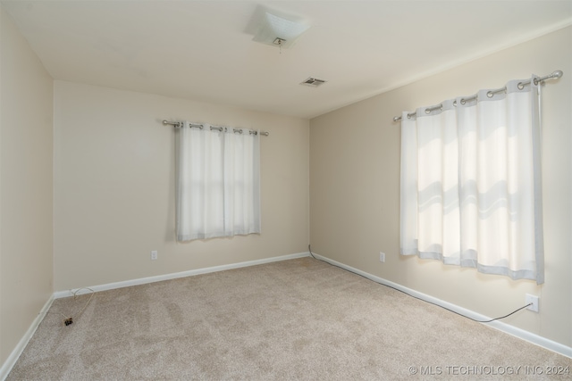 carpeted empty room with plenty of natural light