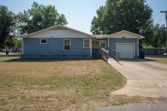 ranch-style home with a front yard and a garage