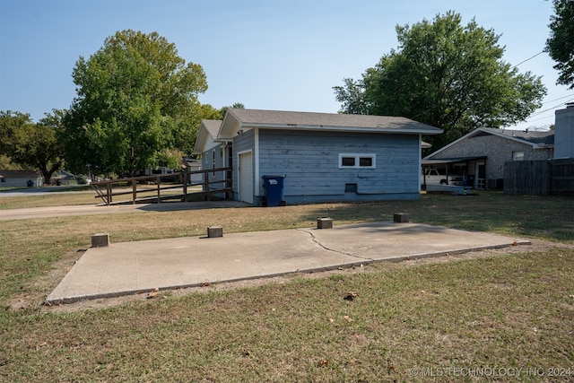 back of property featuring a lawn