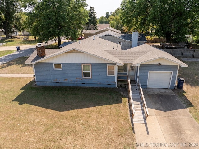 view of front of house with a front yard and a garage