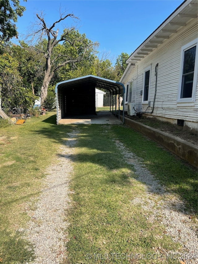 view of yard featuring a carport and ac unit