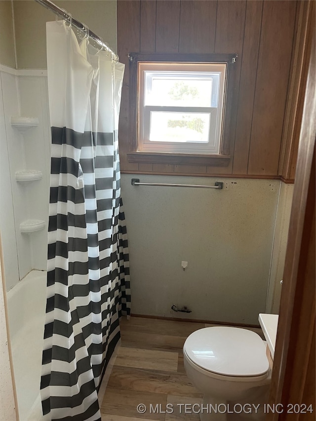 bathroom with hardwood / wood-style flooring and toilet