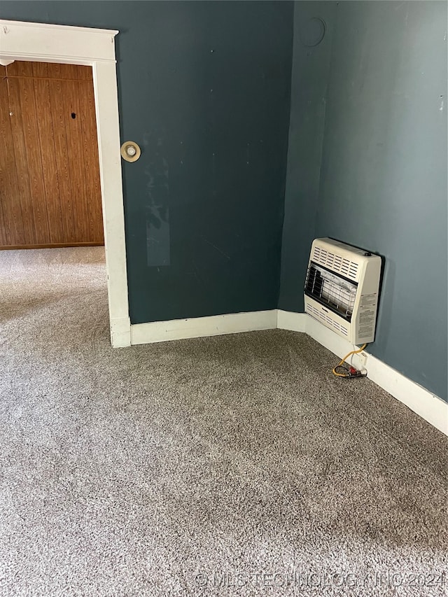 unfurnished room featuring heating unit