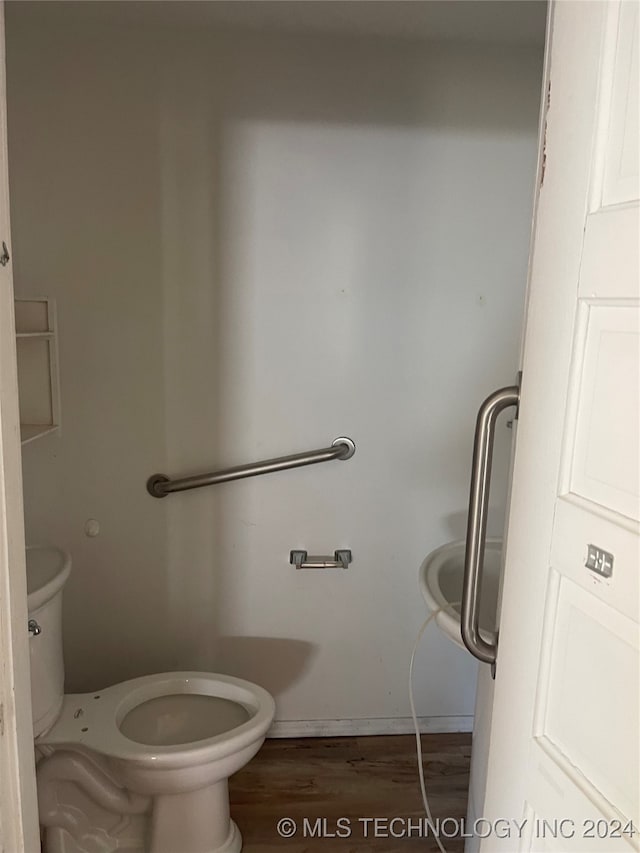 bathroom featuring hardwood / wood-style flooring and toilet