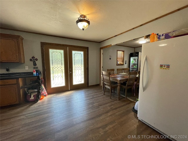 dining room featuring dark wood-style floors, french doors, and crown molding