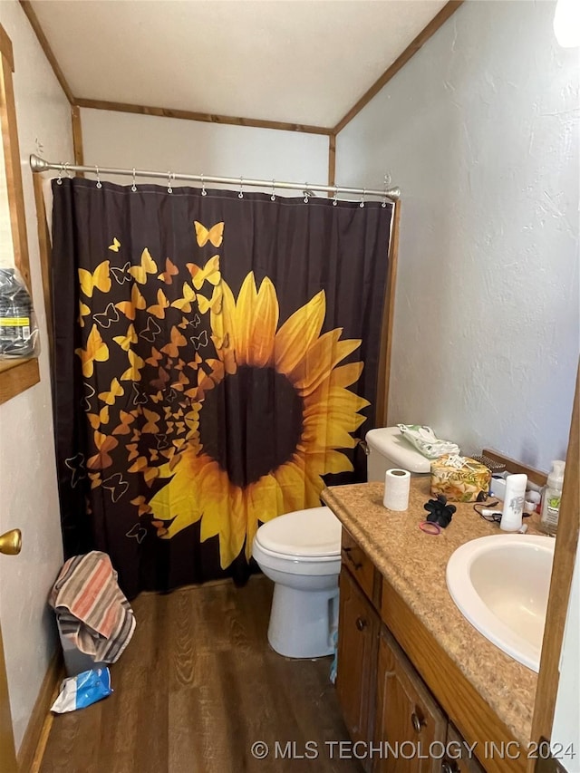 bathroom with toilet, wood finished floors, vanity, ornamental molding, and a shower with curtain